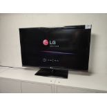 LG 42LD450 television with remote control and power cord