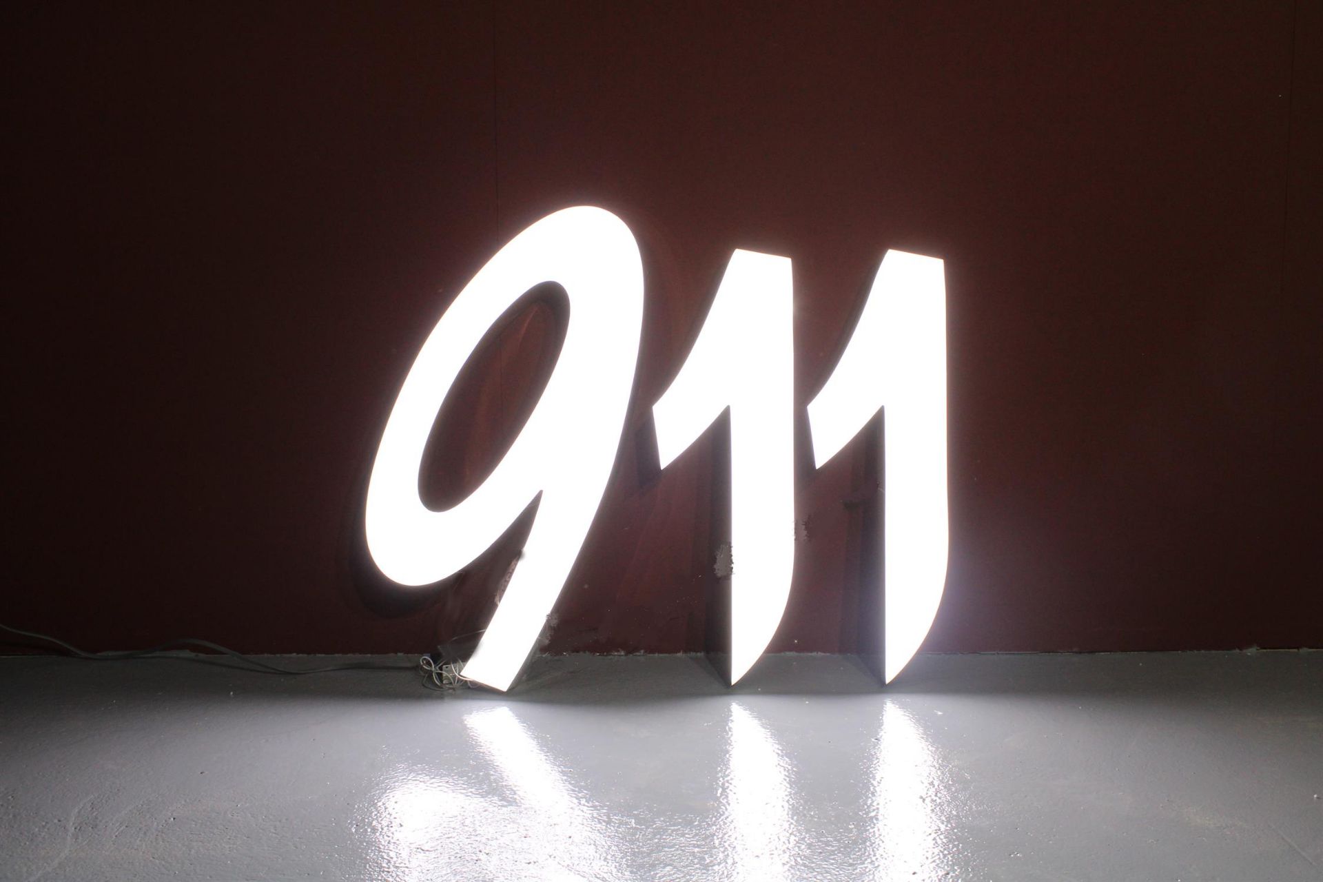 A large Illuminated Sign in the Style of the Porsche Number 911