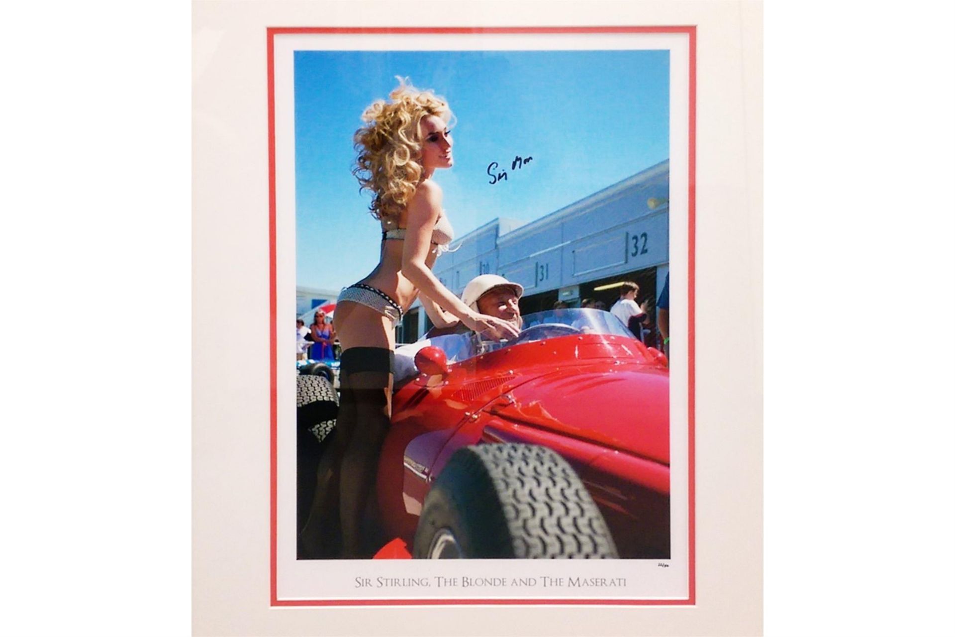 'Sir Stirling, the Blonde and the Maserati'. Signed by Sir Stirling Moss OBE