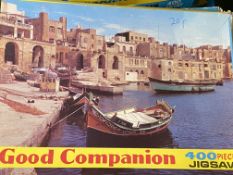 Twenty two opened Good Companion jigsaw puzzles