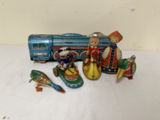 Four tin push along toys