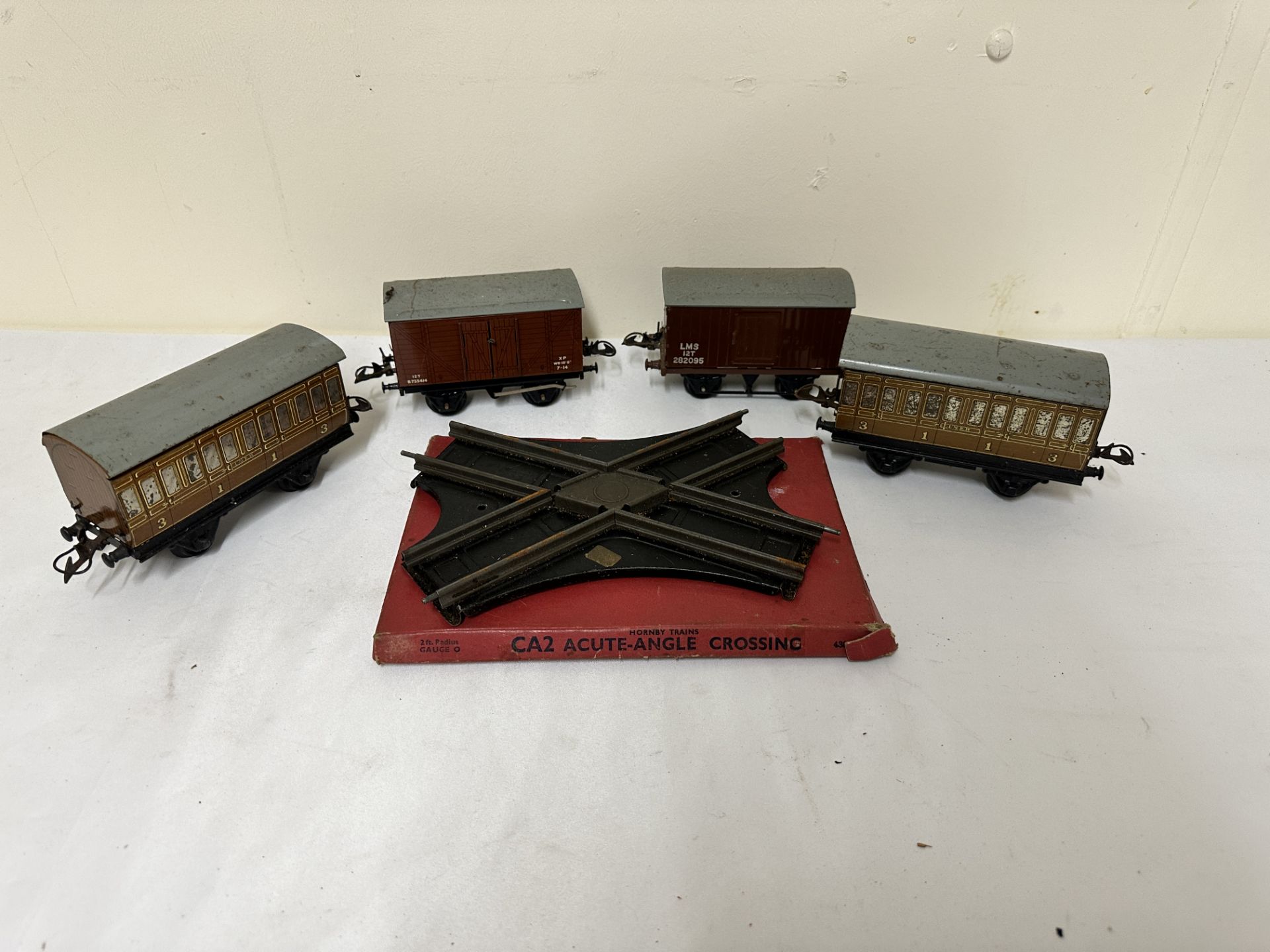 Two Hornby 0 gauge coaches, two wagons and acute angle crossing