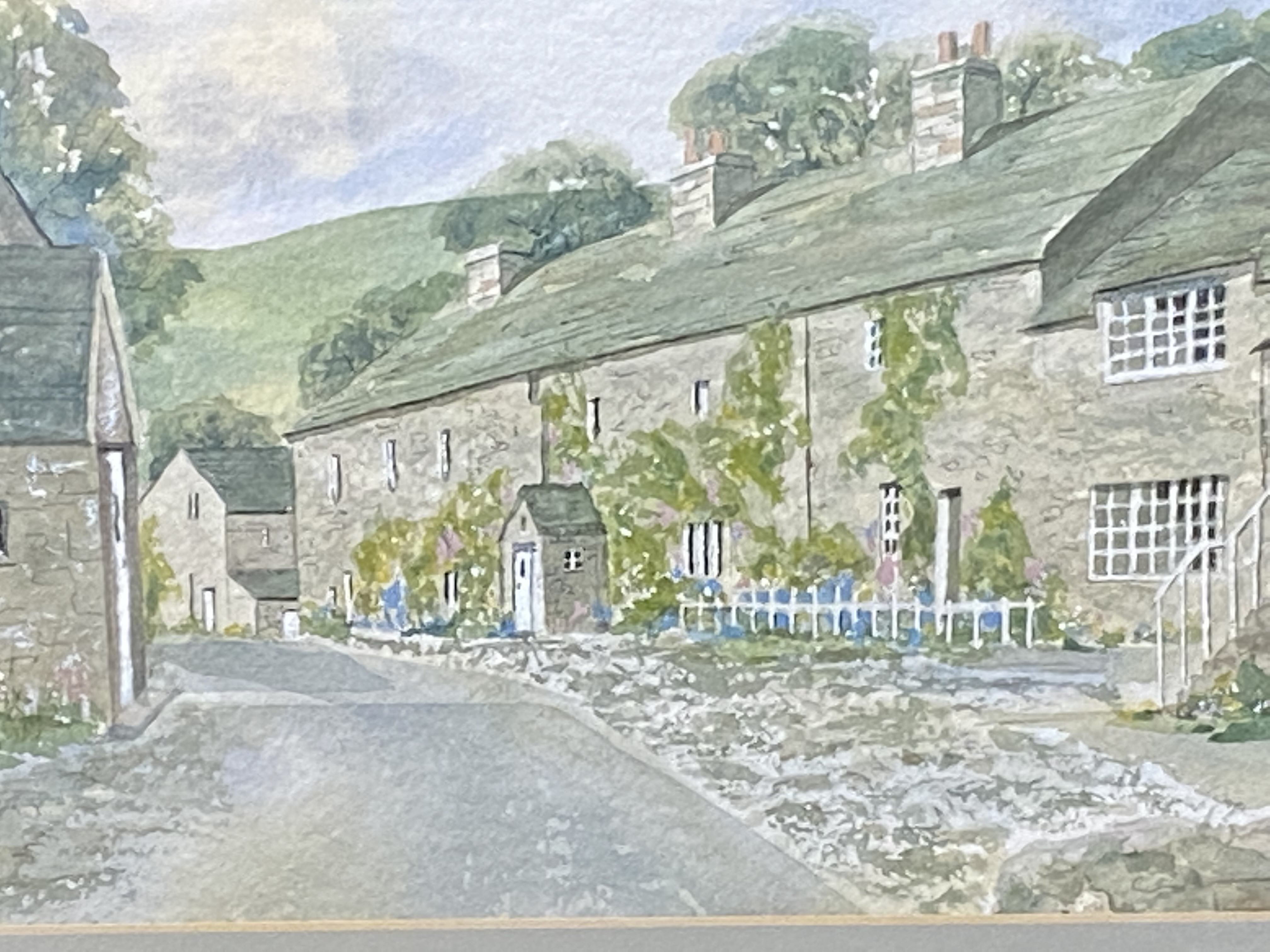 Framed and glazed watercolour of a village street