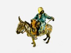 AFTER FRANZ BERGMAN; a cold painted bronze depicting a tradesman riding a donkey