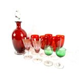 A cranberry glass decanter, five cranberry glass wine glasses and other glasses