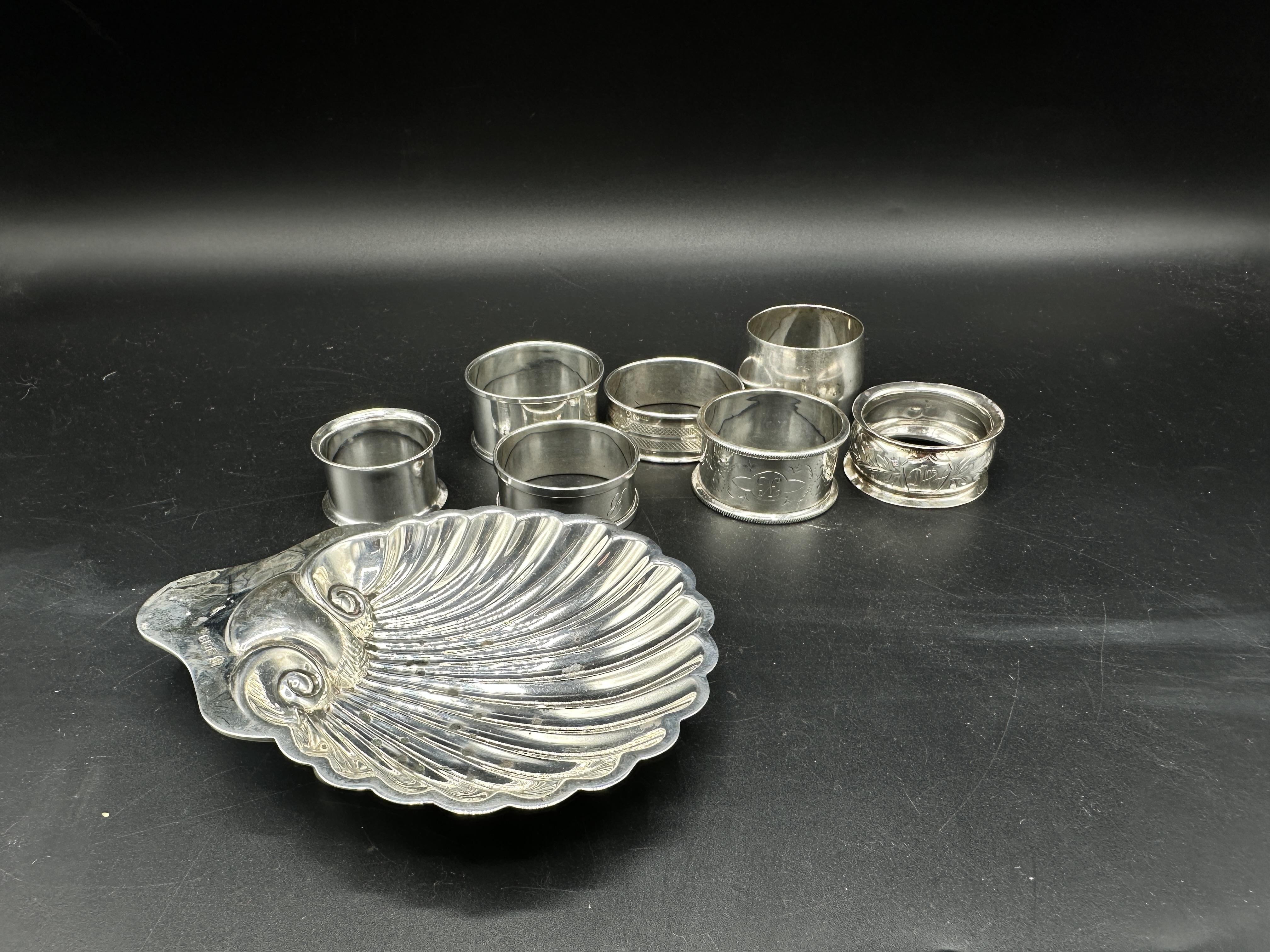 Silver shell dish together with six silver napkin rings