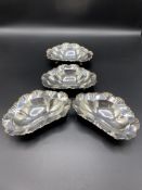 Four silver three footed dishes, 1906/7