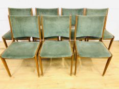 Seven teak dining chairs