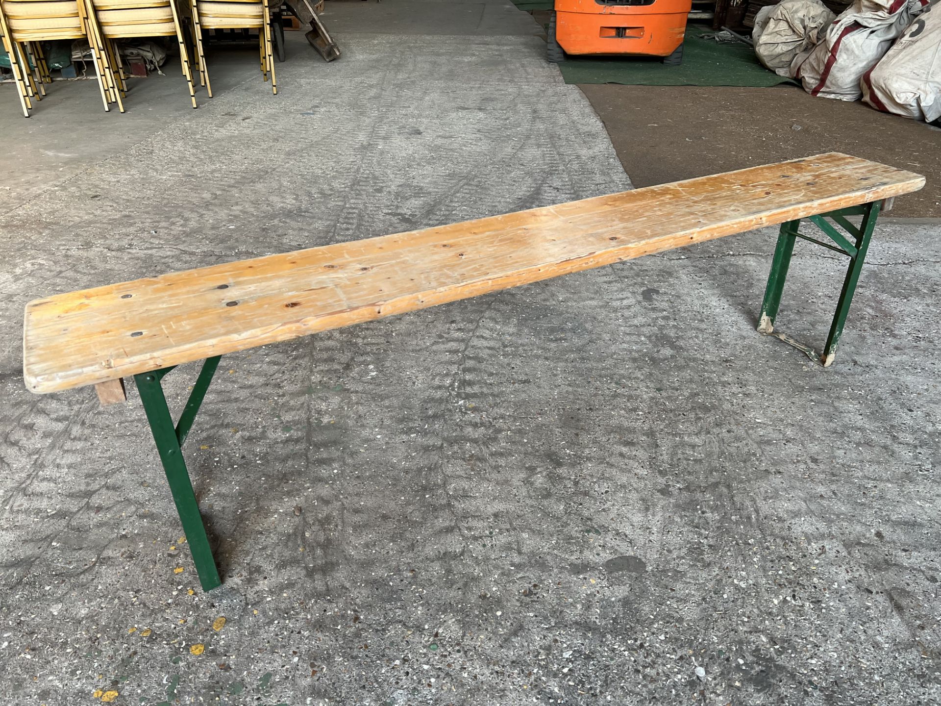 10 no 6ft long wooden benches with metal folding legs. This lot is subject to VAT