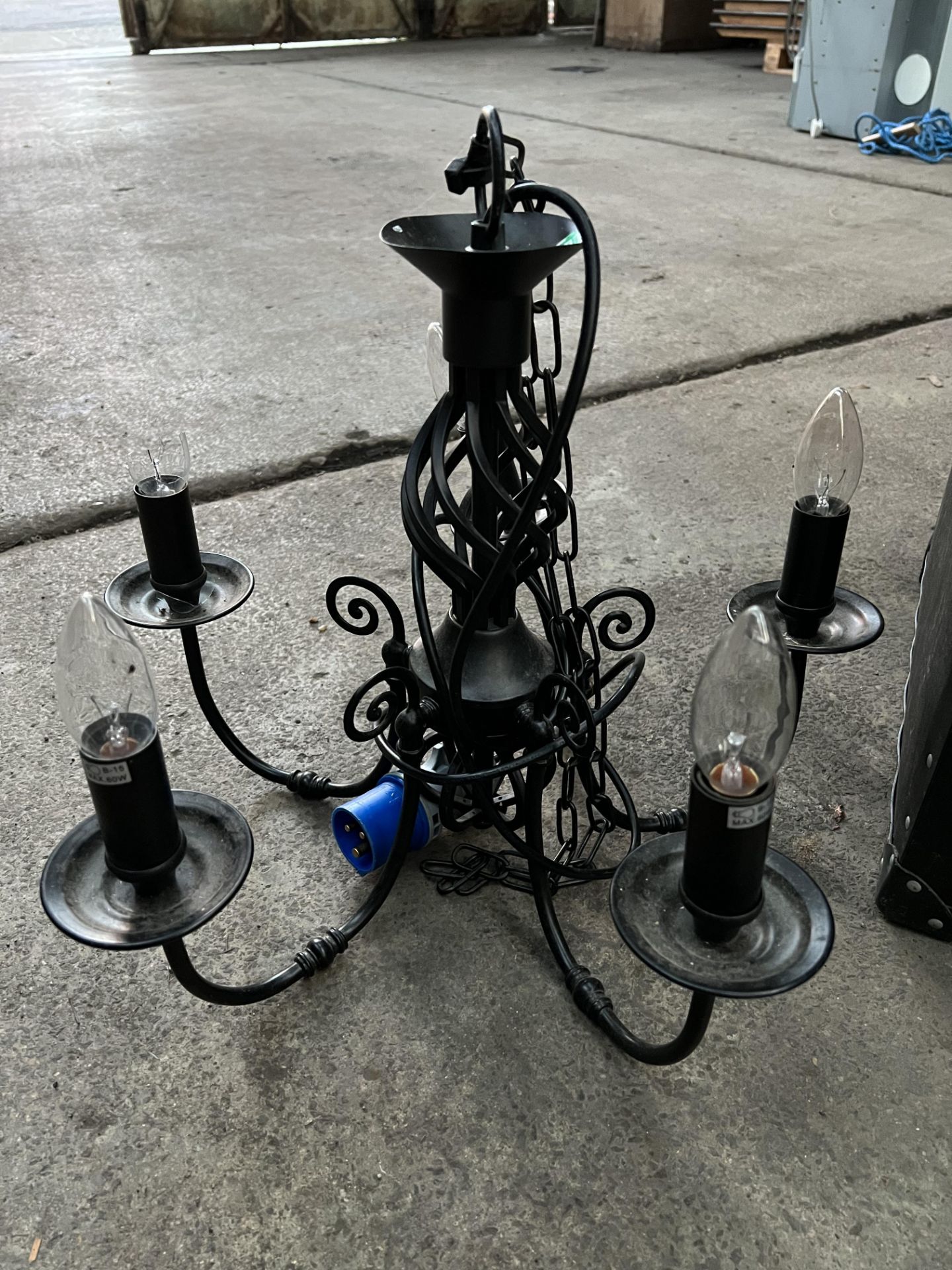 5 light black wrought iron chandelier; with ten spare new bulbs. This lot is subject to VAT