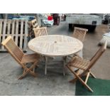 4ft diameter teak circular table with 4 folding teak chairs. This lot is subject to VAT