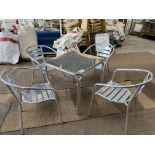 5 aluminium cafe tables with 20 aluminium armchairs. This lot is subject to VAT