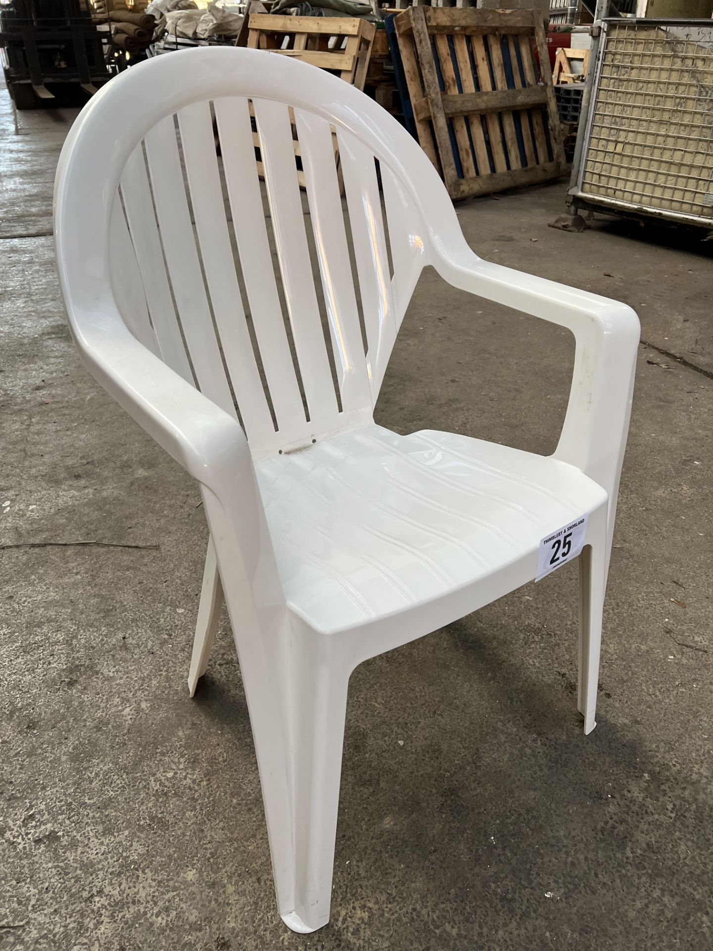 50 white resin garden armchairs. This lot is subject to VAT