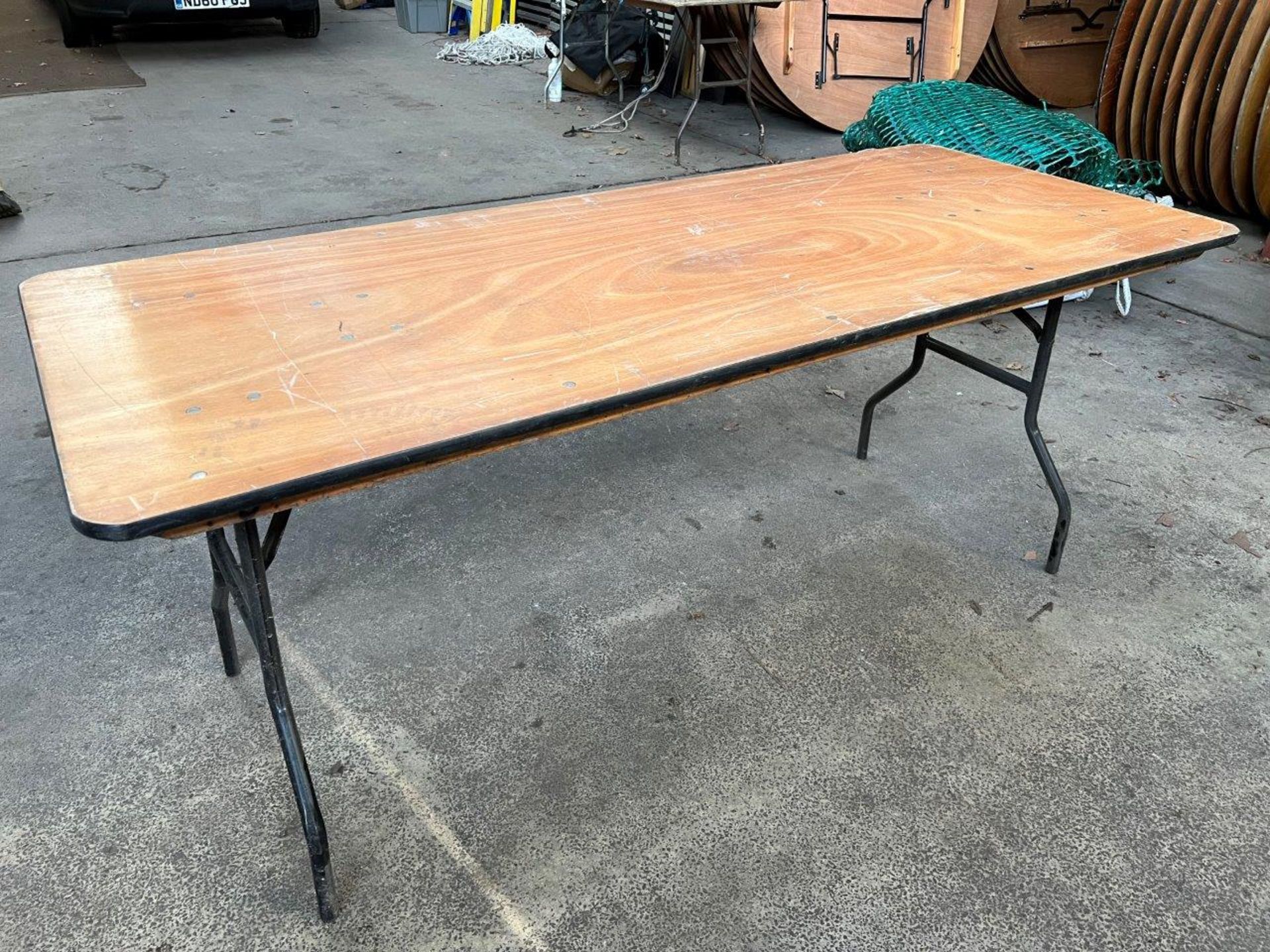22 no 6ft trestle tables with metal folding legs and plywood top. This lot is subject to VAT.