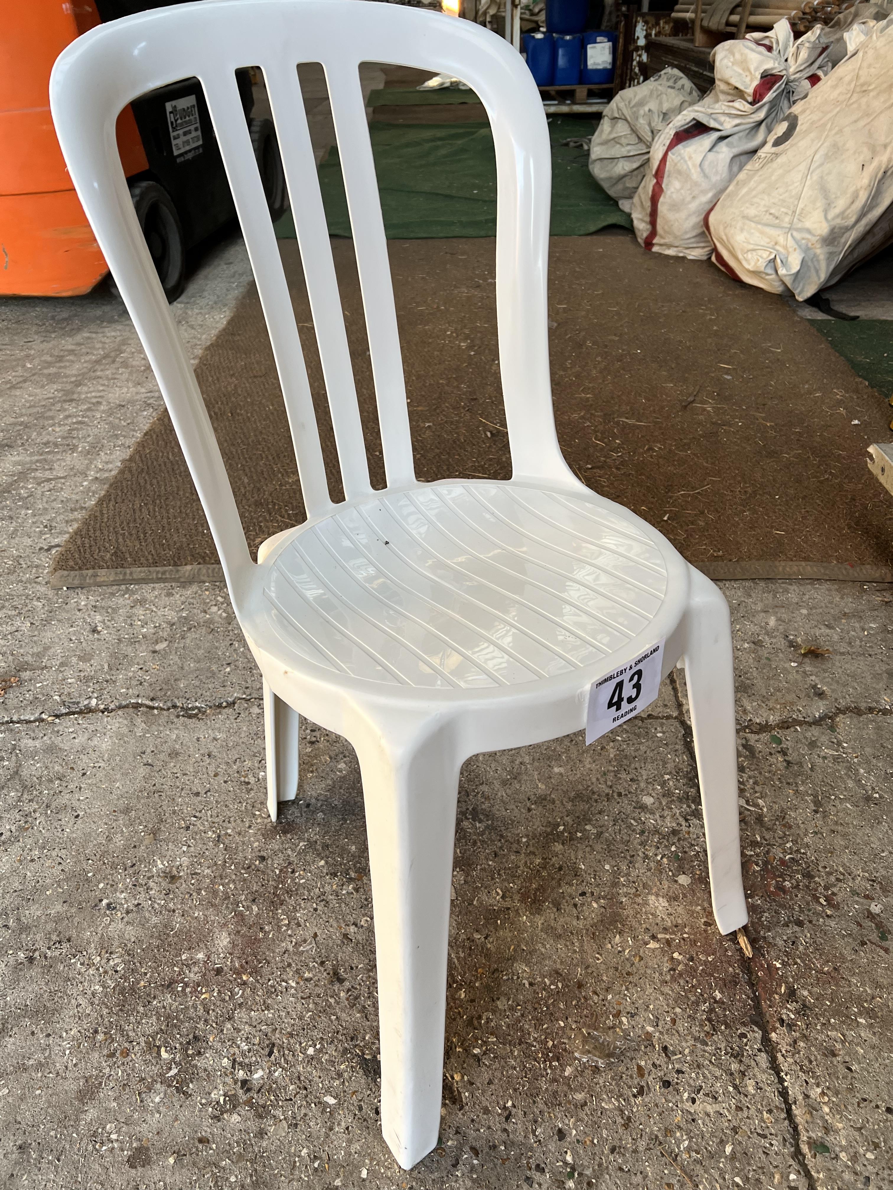 50 white resin bistro chairs. This lot is subject to VAT