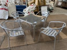 5 aluminium cafe tables with 20 aluminium armchairs. This lot is subject to VAT