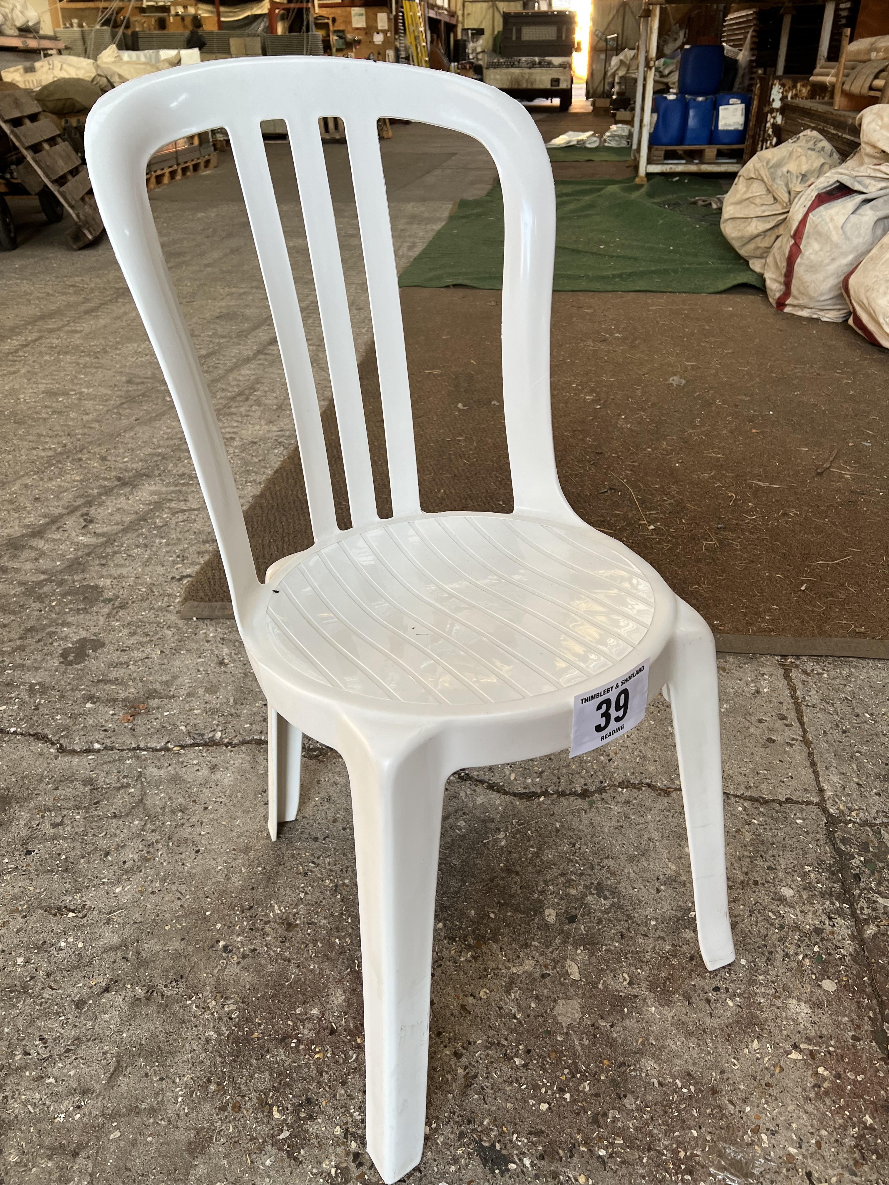 50 white resin bistro chairs. This lot is subject to VAT