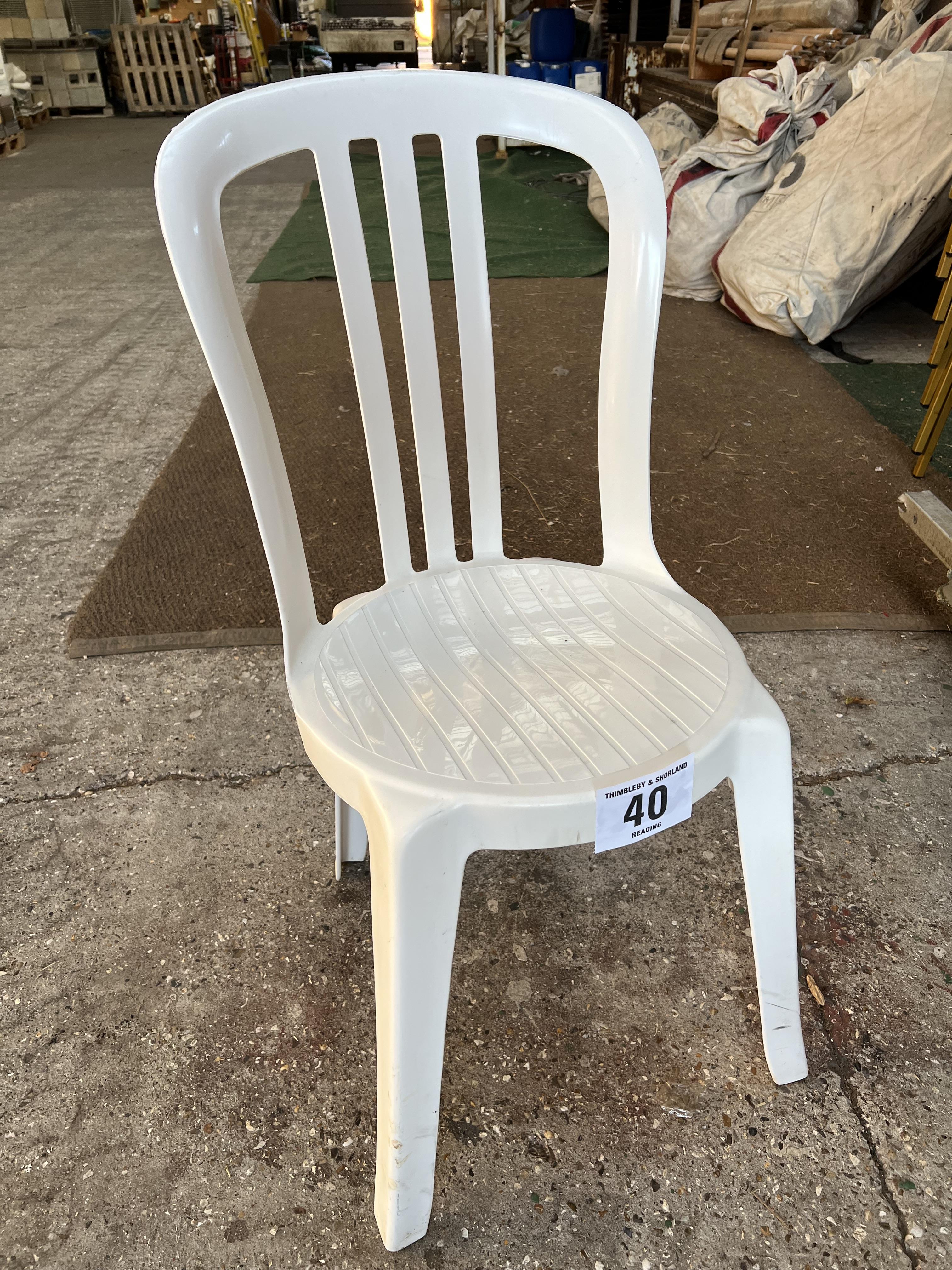 50 white resin bistro chairs. This lot is subject to VAT