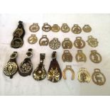 24 assorted horse brasses, including four singles on straps and tow on a strap.