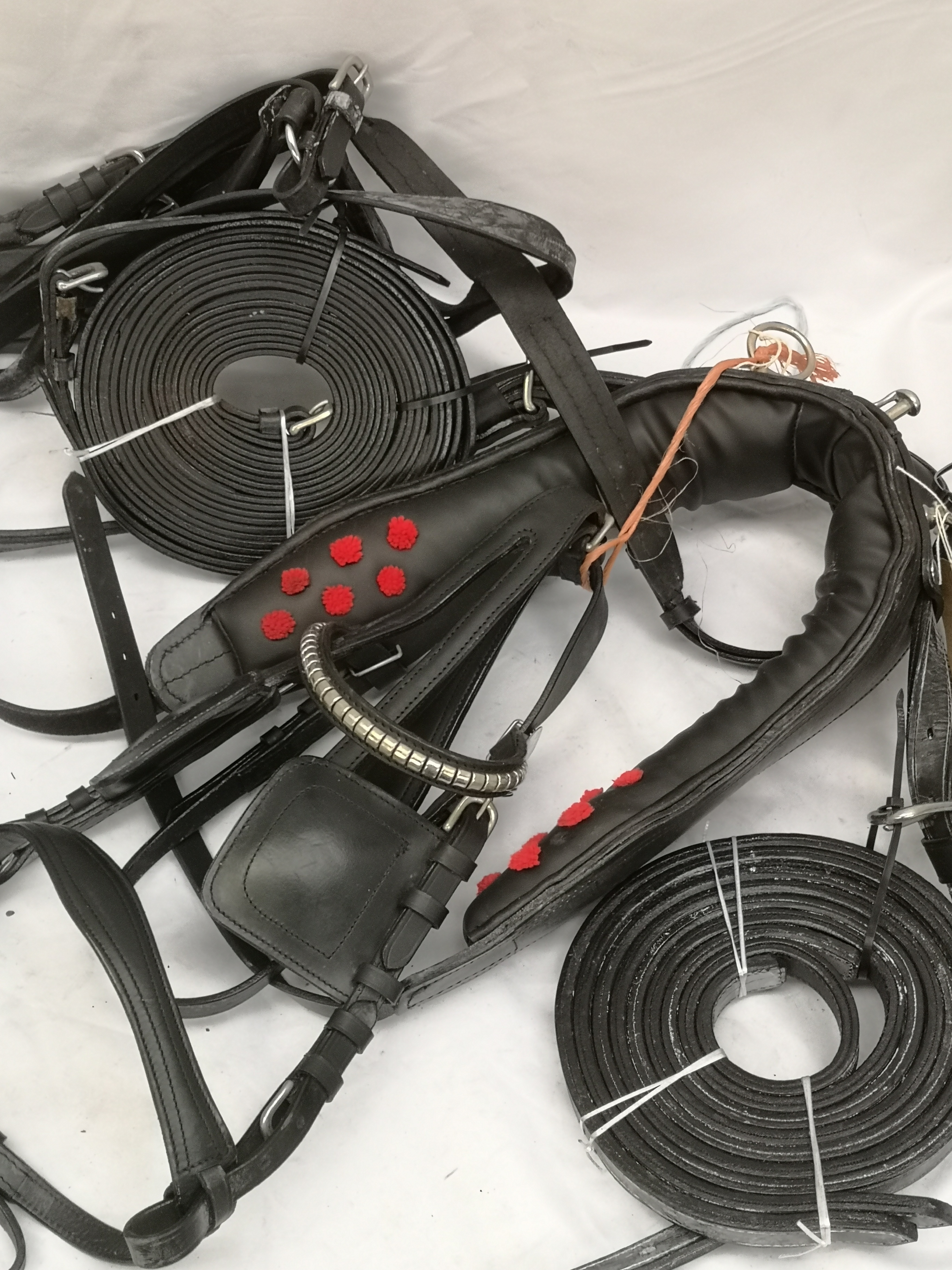 Set of pony black and white metal harness. This lot carries VAT.