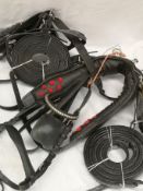 Set of pony black and white metal harness. This lot carries VAT.