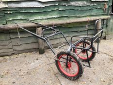 EXERCISE CARRIAGE FRAME painted black with new red wire wheels on pneumatic tyres.