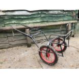 EXERCISE CARRIAGE FRAME painted black with new red wire wheels on pneumatic tyres.