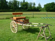 PONY MARKET CART to suit 13hh. Painted brown with cream lining on a cream undercarriage. The seat is