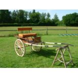 PONY MARKET CART to suit 13hh. Painted brown with cream lining on a cream undercarriage. The seat is