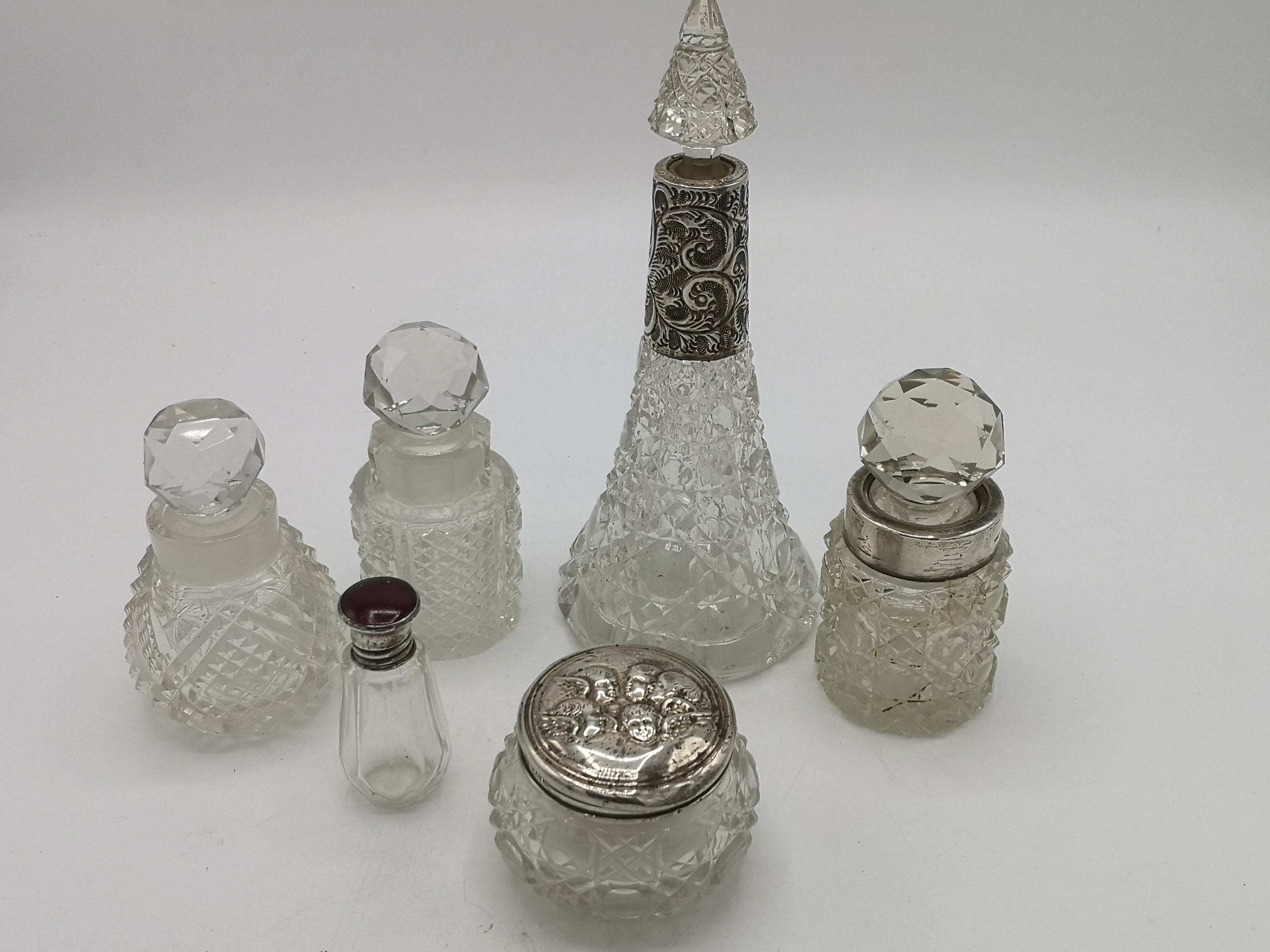 A collection of glass and silver dressing bottles and jars together with two glass bottles