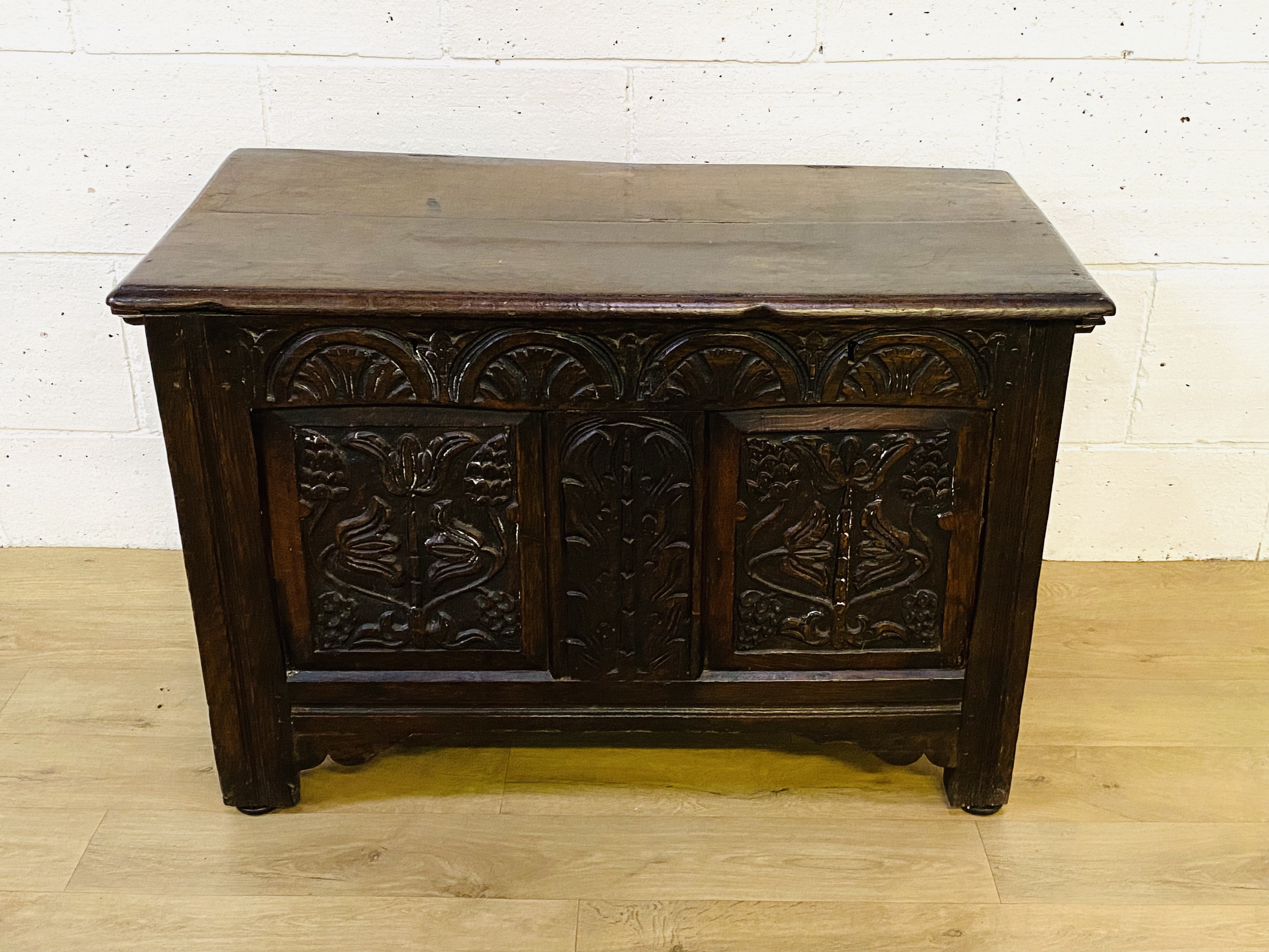 Oak chest with carved panels to front