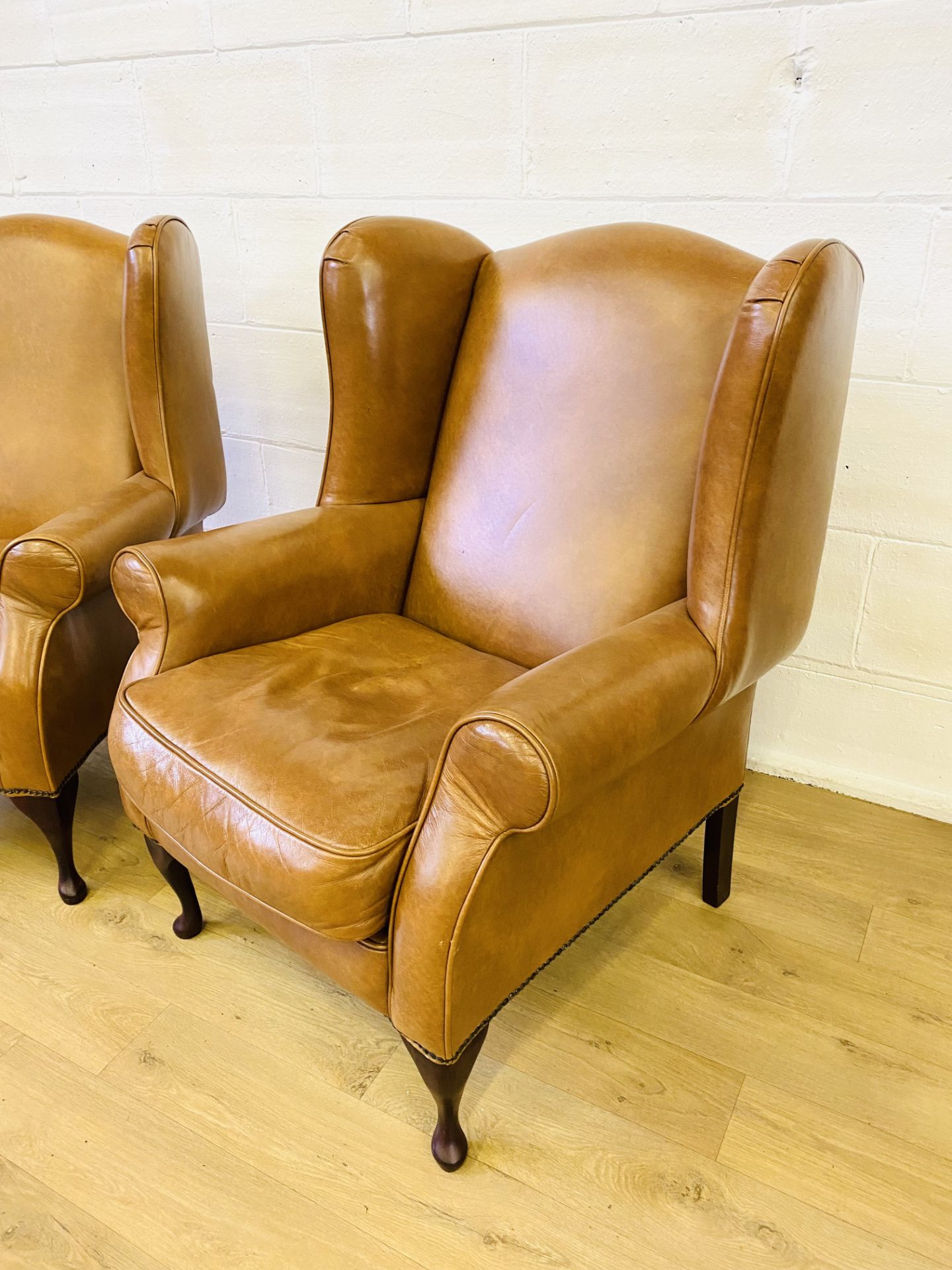 Pair of brown leather style wingback armchairs - Image 2 of 4