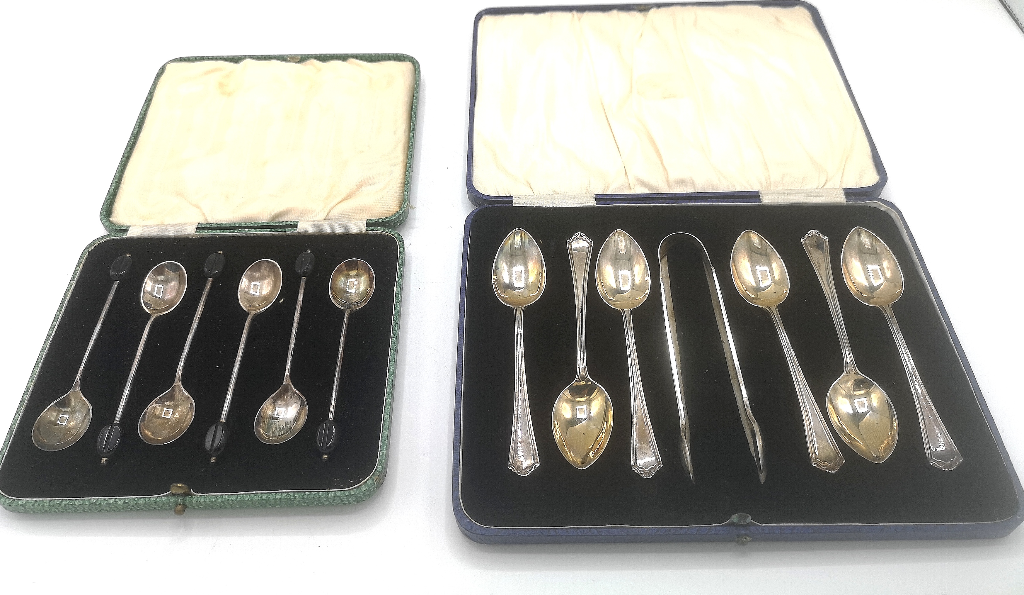 Two sets of silver spoons