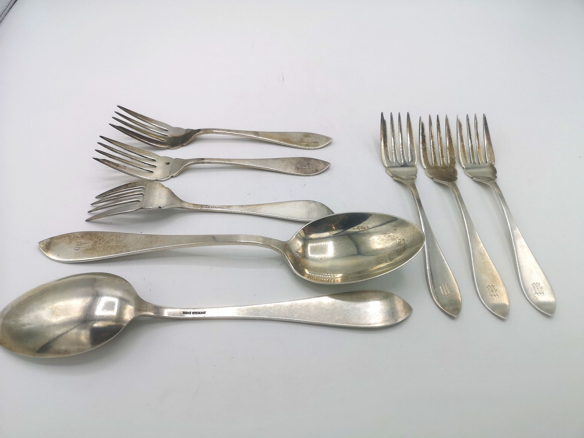 Six Birks silver dessert forks together with two silver table spoons