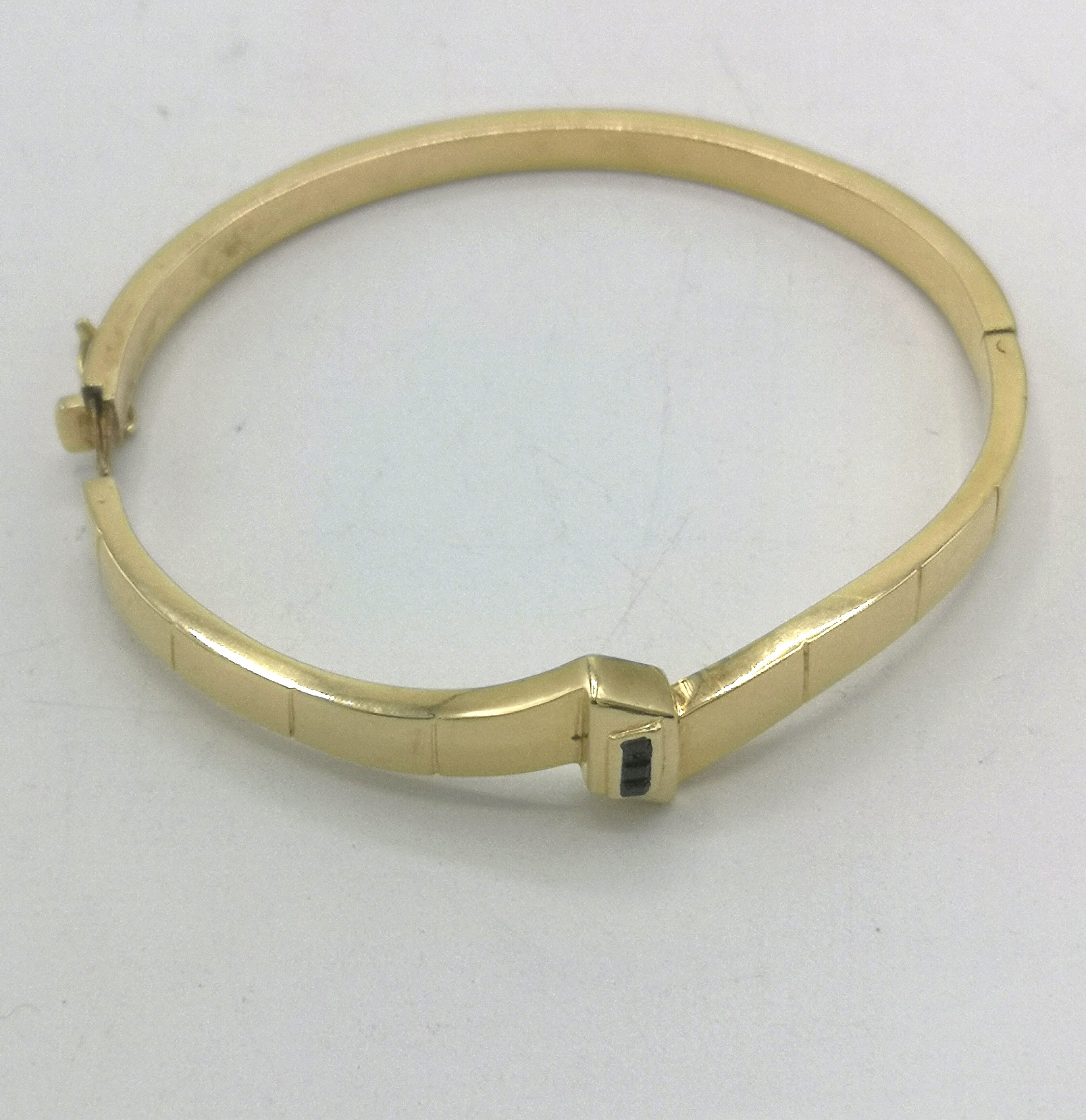 14ct gold bangle set with three pave set diamonds