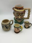 Three ceramic character jugs together with a ceramic tankard