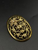 Yellow metal brooch set with seed pearls and a diamond