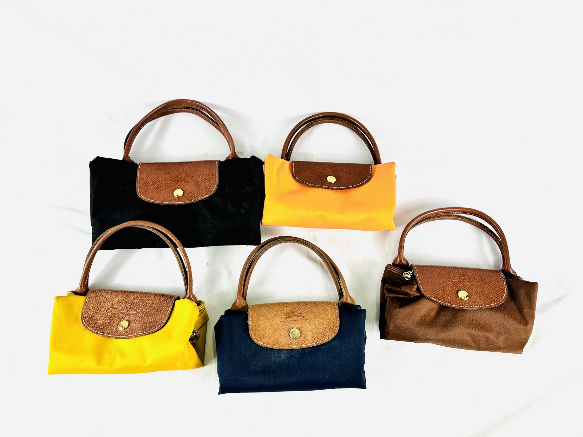 Five Longchamps fold out canvas bags with leather trim