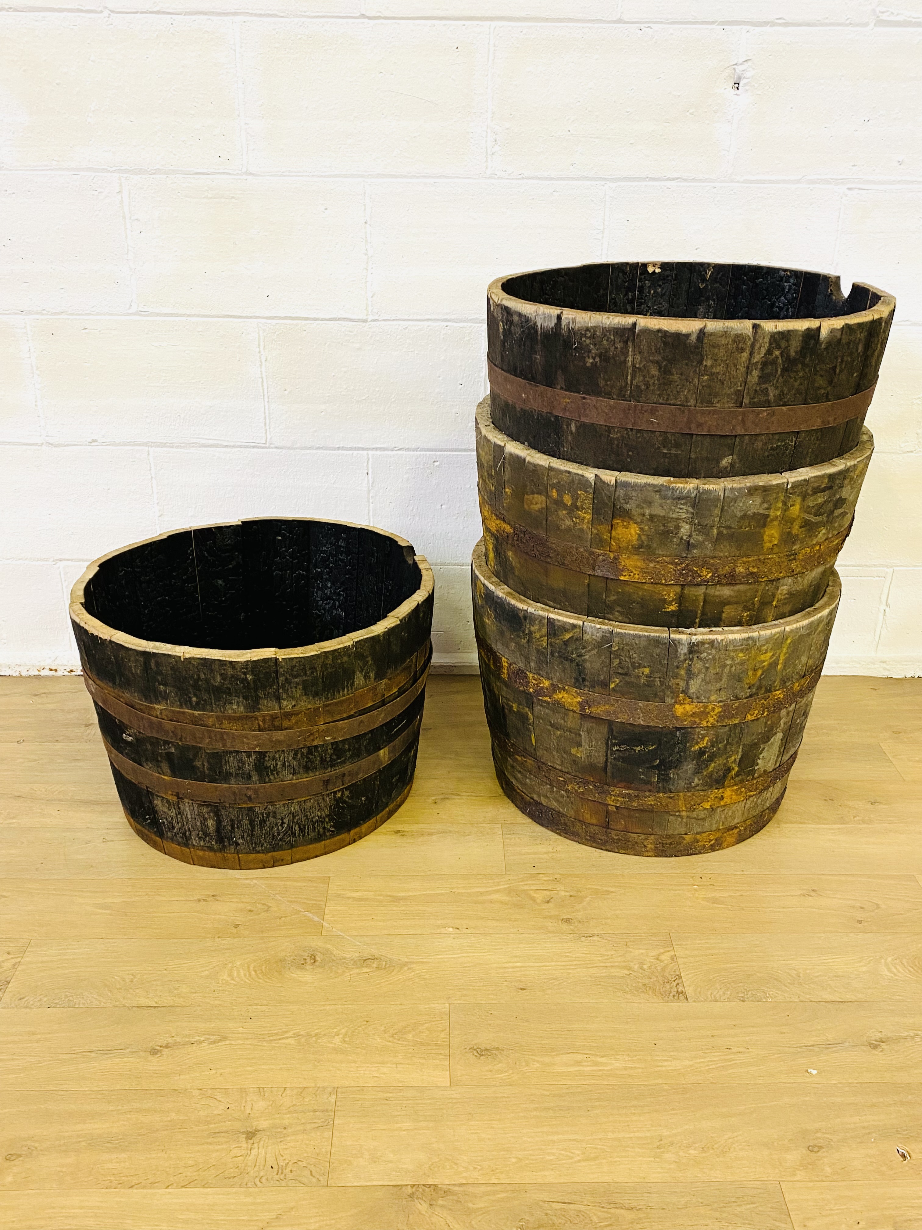 Four wood half barrels with metal bands
