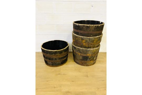 Four wood half barrels with metal bands - Image 1 of 3