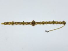 Gold filigree bracelet set with rubies and peridot