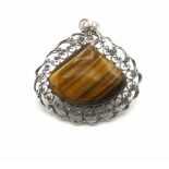 Silver pendant set with a tiger eye