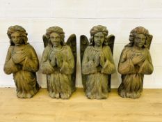 Four carved pine angels