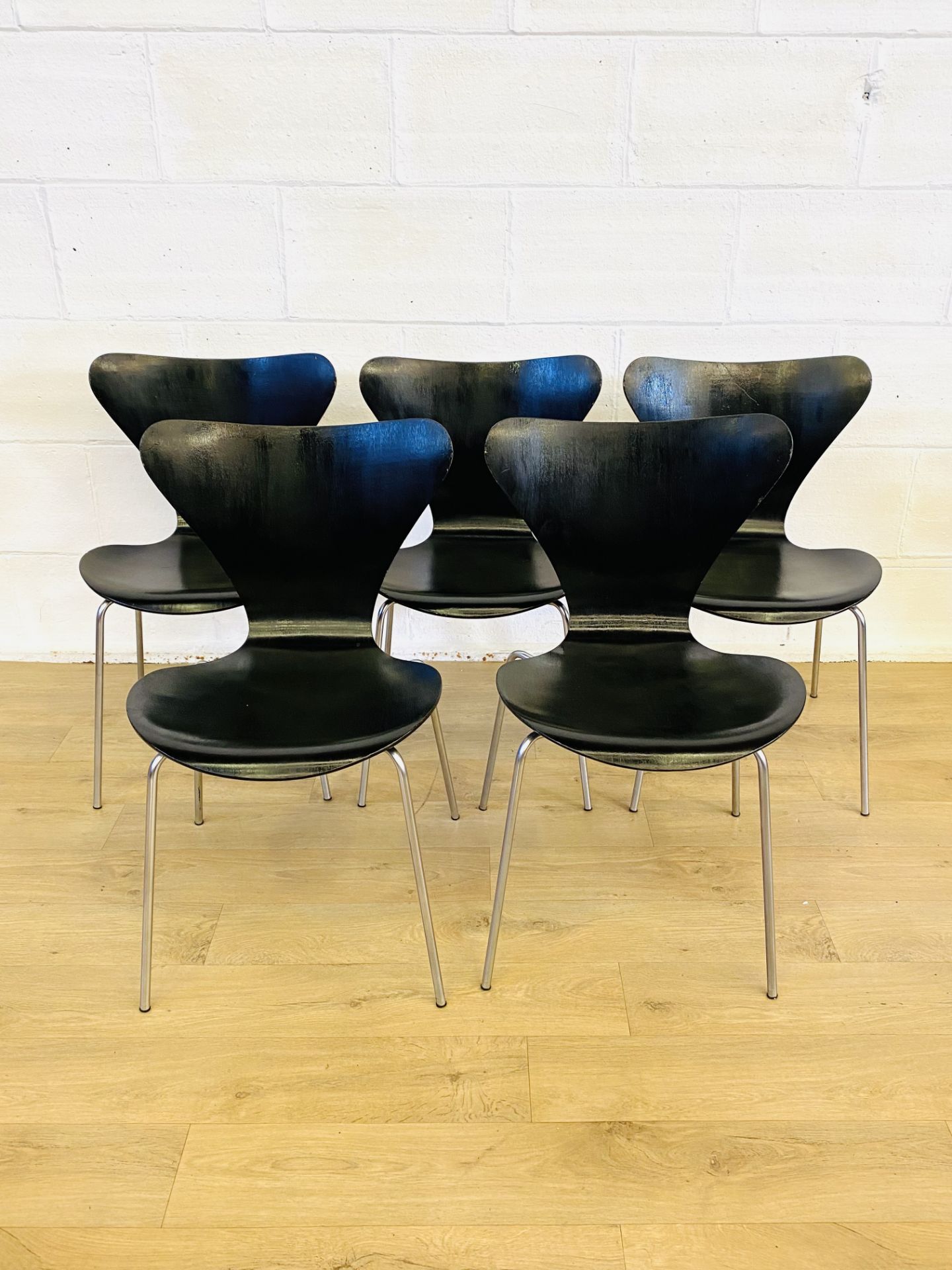 Five black Fritz Hansen chairs