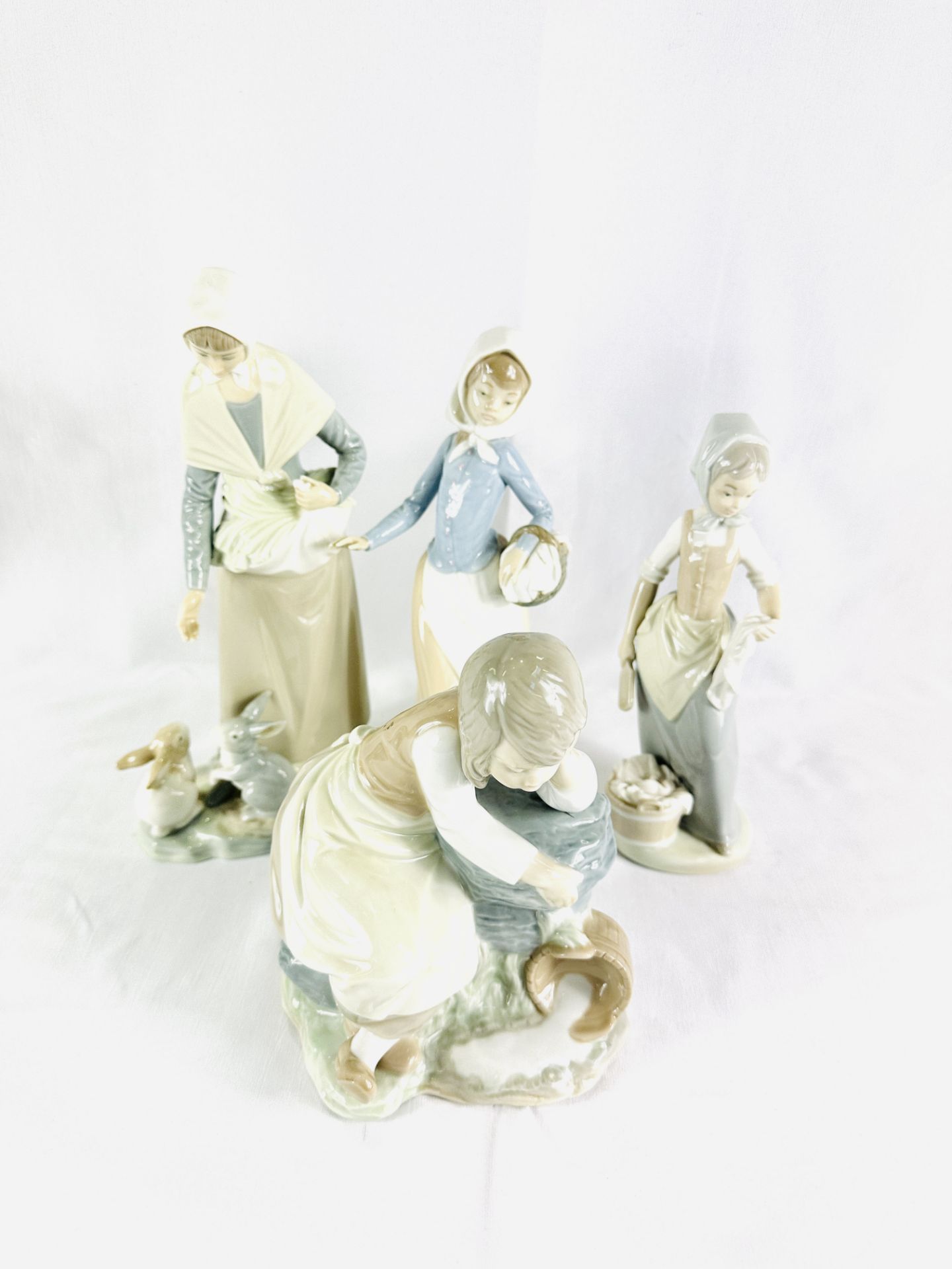 Four Neo figures; together with four Lladro figures