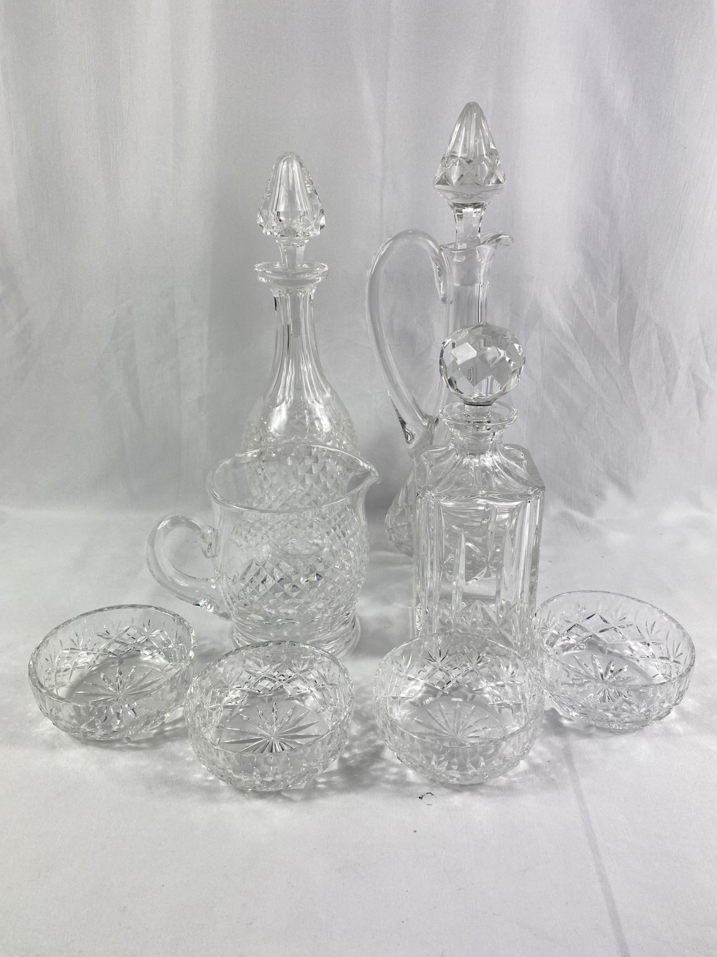 Three crystal glass decanters and other glassware