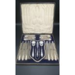 Box containing a silver six place breakfast set