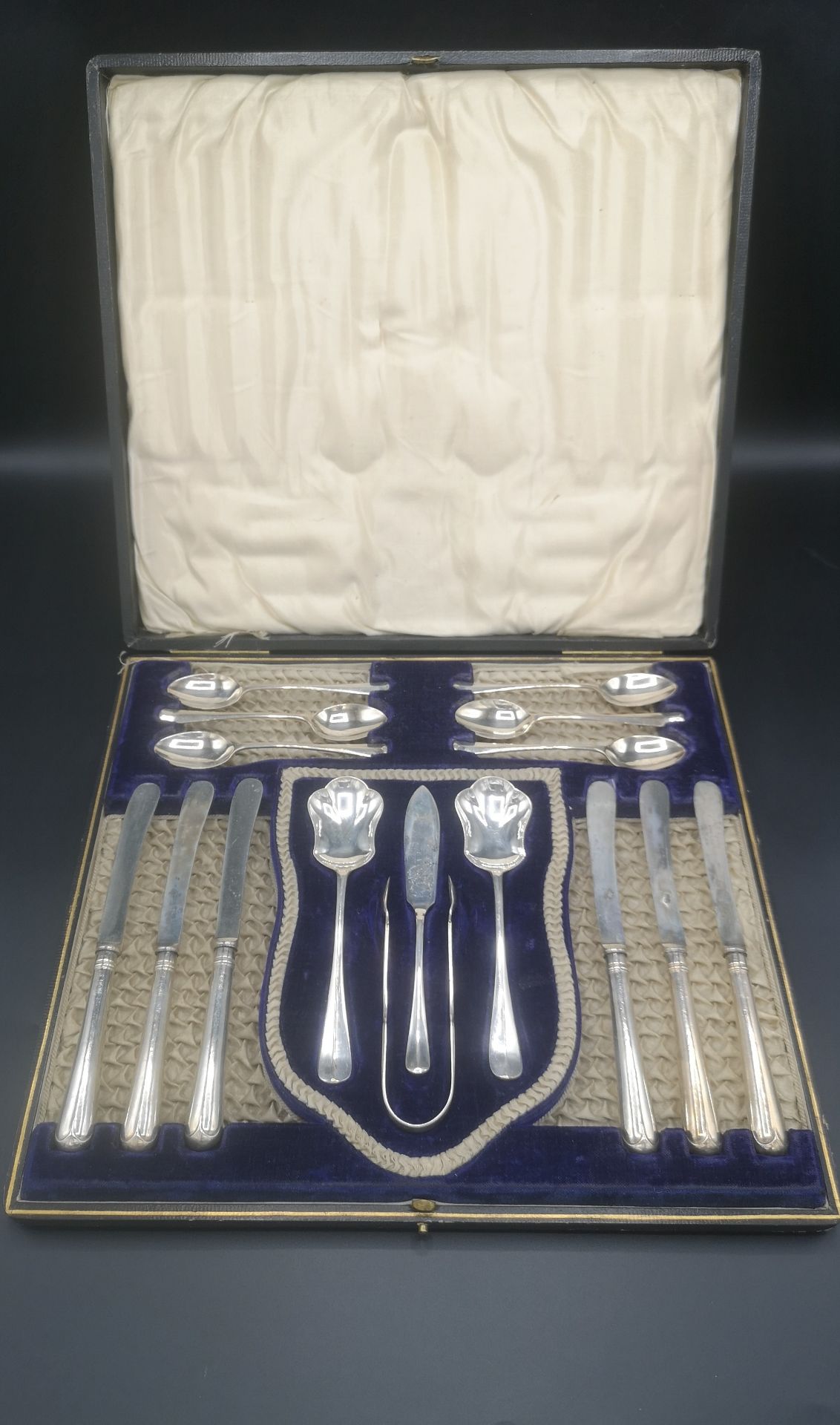 Box containing a silver six place breakfast set