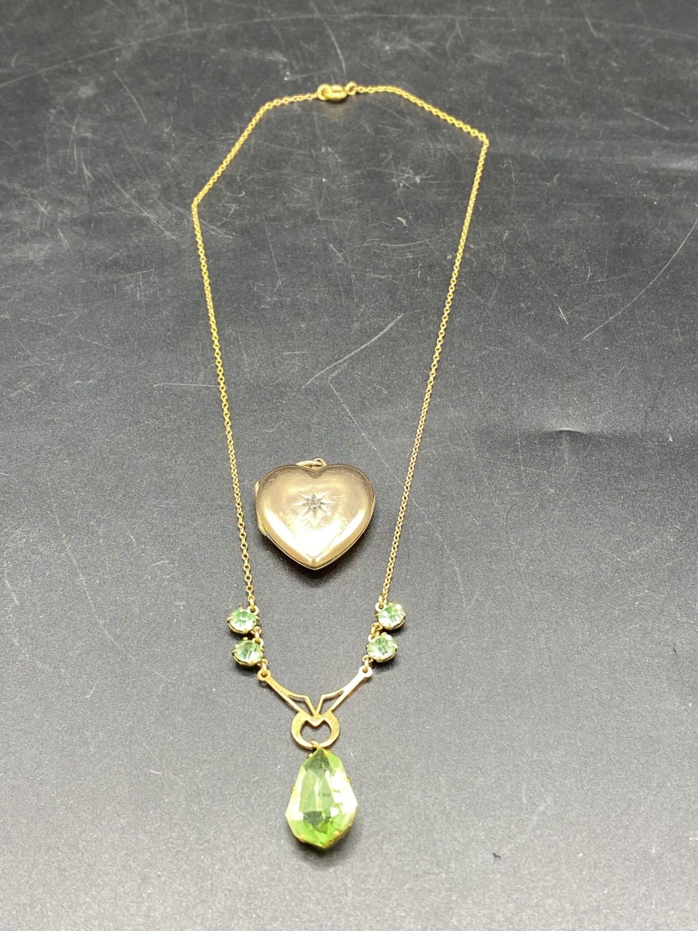 9ct gold necklace set with a pale green teardrop and a 9ct gold diamond set locket