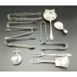 Silver tea strainer with other silver spoons together with silver plate sugar tongs